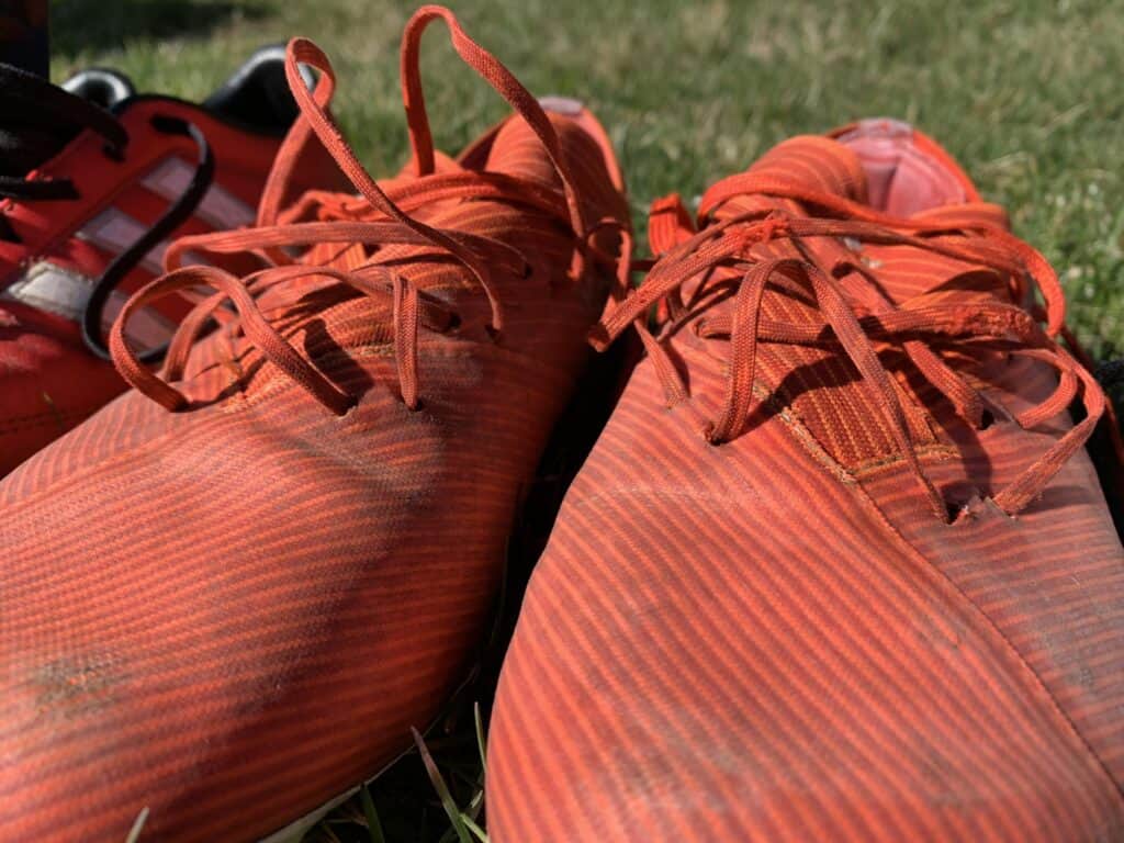 A picture of red synthetic Adidas soccer cleats. 