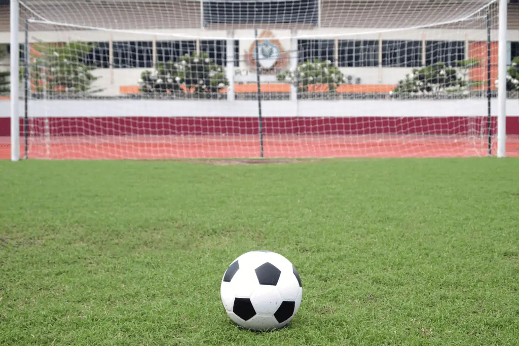 A soccer ball is sitting on the penalty spot 12 yards from the center of the goal.