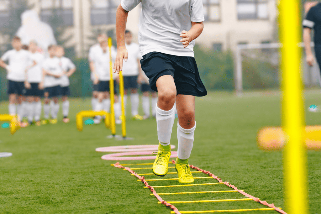 A soccer player does a ladder drill during practice.
